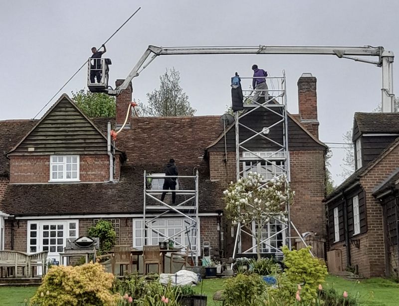 The Moss Cleaners using cherry picker and scaffolding to clean roof safely and professionally in 21 Cambridge Rd, Southall UB1 3EY, UK, 21 Cambridge Rd, Southall UB1 3EY, UK